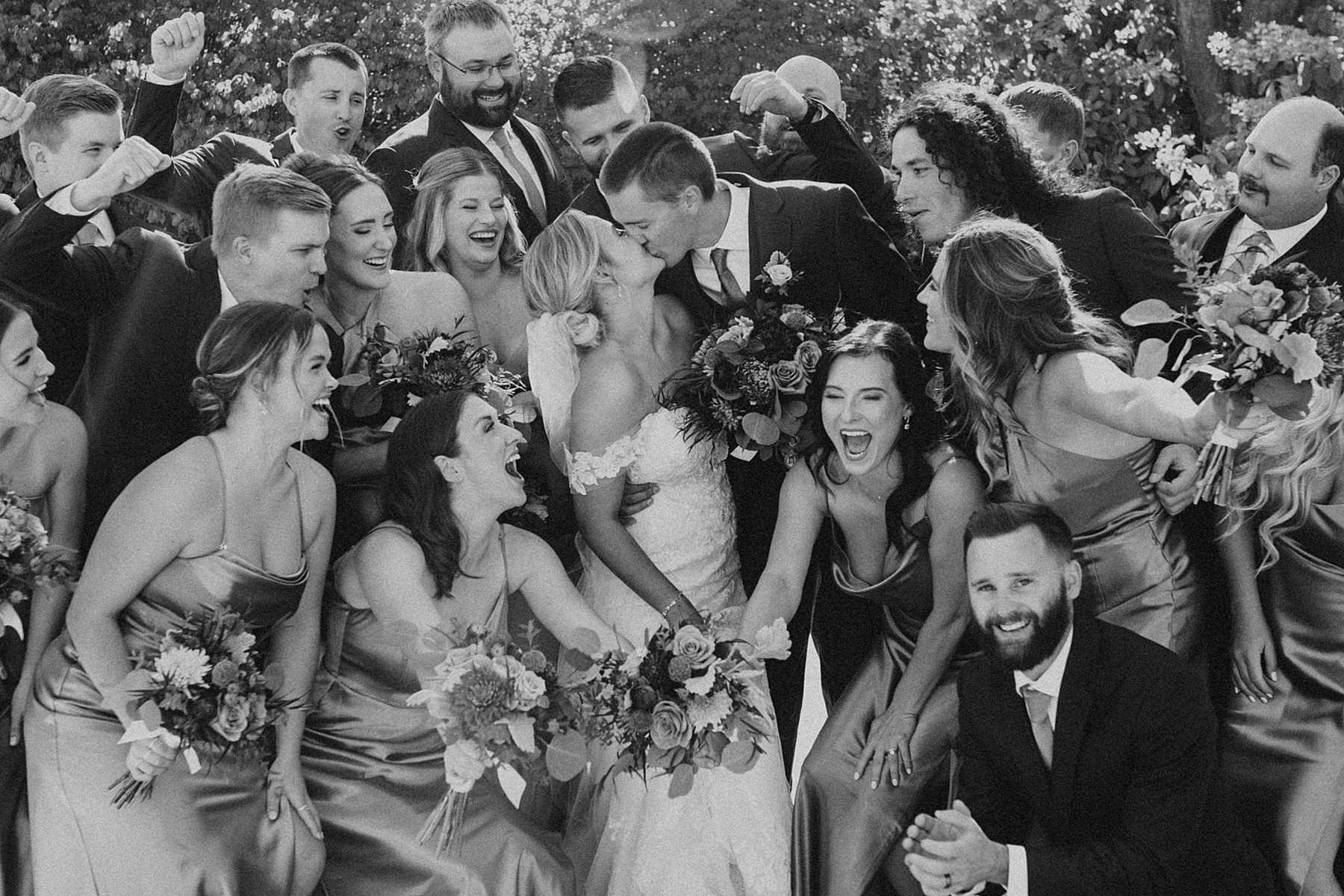 no empty photos on your wedding day when everyone crams in the whole bridal party and bride and groom black and white