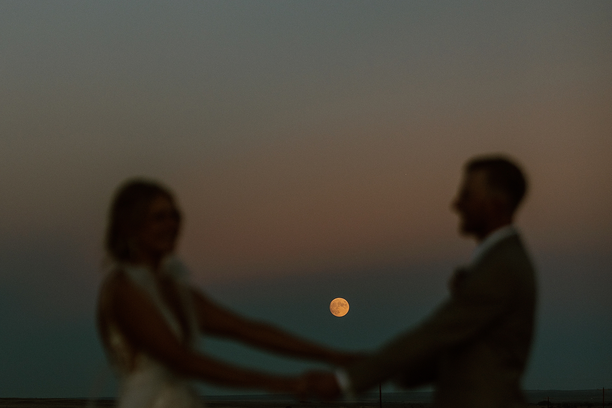 nighttime photography of bride and groom on wedding day