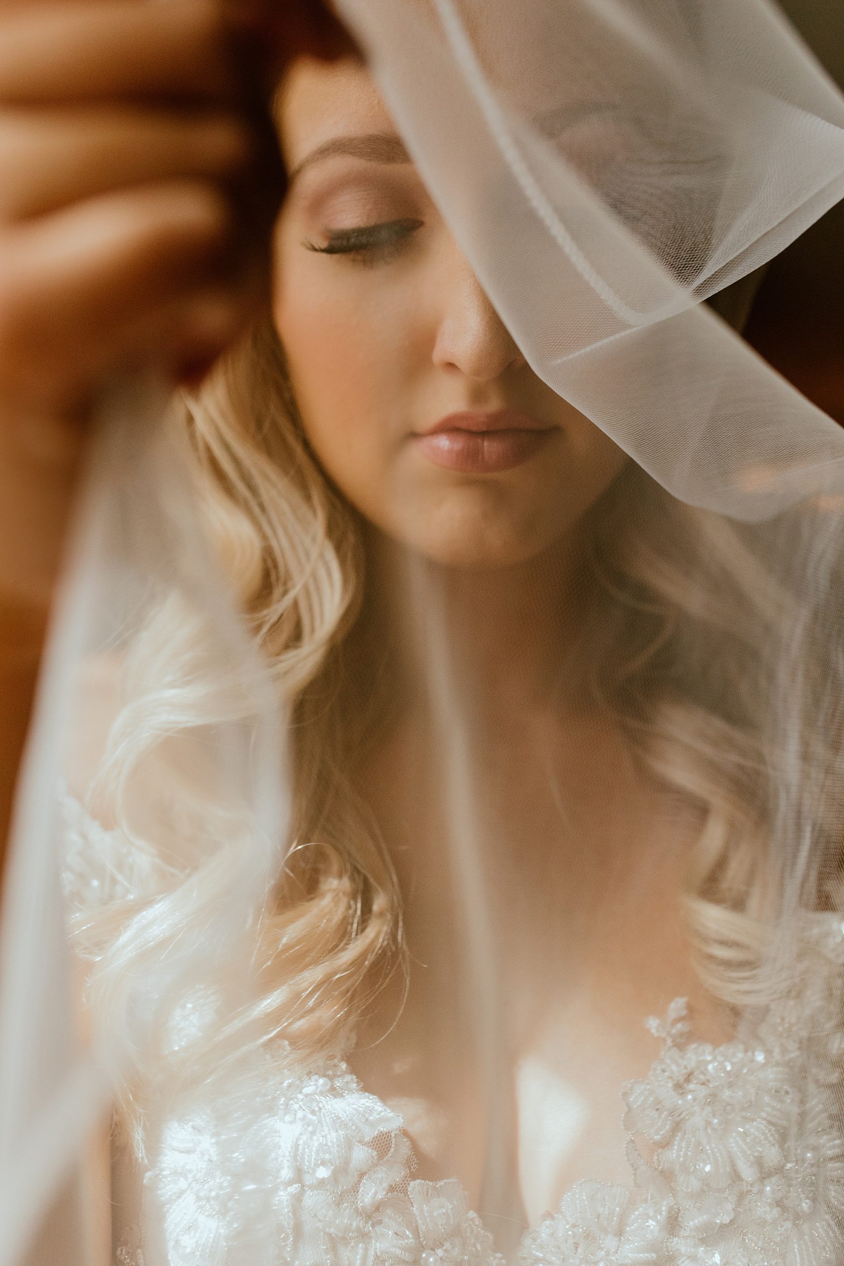 bride with whispy wedding veil as her wedding headpiece