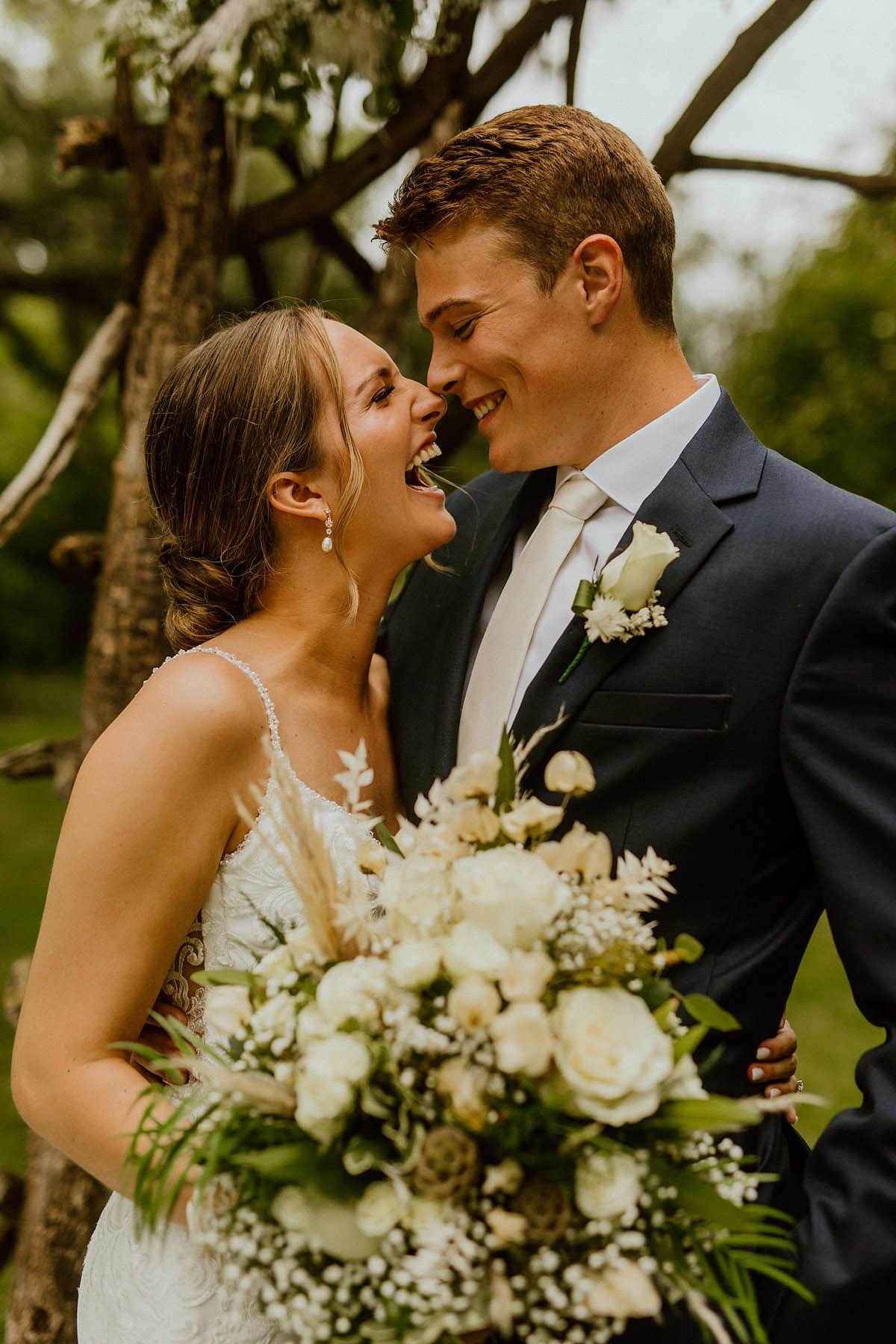 capture the emotion of a bride and groom on their wedding day. no empty photos. large flower bouquet. 