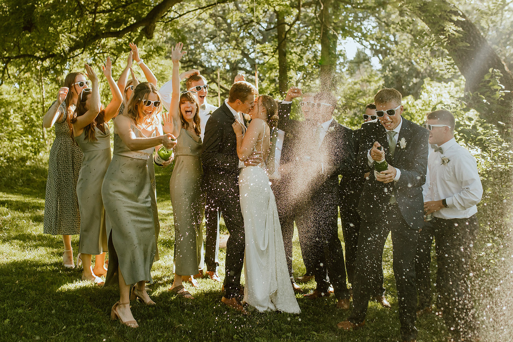 champagne pop with bridal party for fun wedding photo