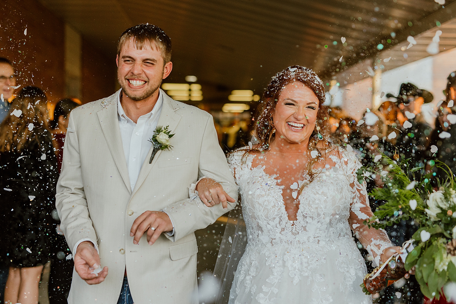 epic bridal party photo as bride and groom leave wedding ceremony