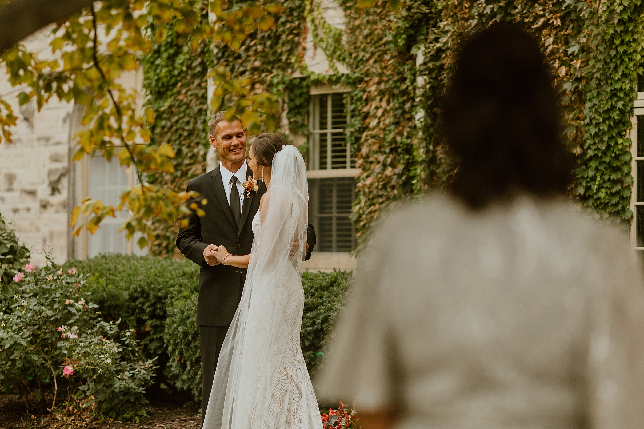 capture emotion of dad first look with bride as mother looks on